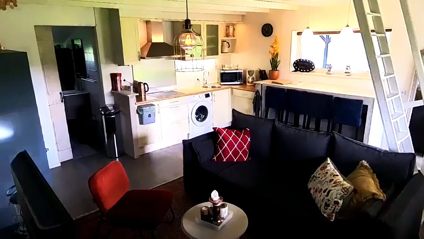 Living area with रसोई, sofa and stairs to the स्लीपिंग लॉफ्ट.